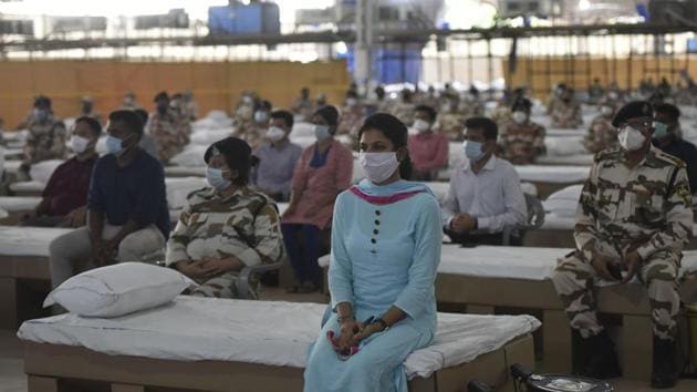 Medical professionals and security personnel during the inauguration of Sardar Patel Covid Care Centre and Hospital by Union home minister Amit Shah and Delhi chief minister Arvind Kejriwal at Radha Swami Satsang Beas campus in Chhatarpur, New Delhi on Saturday. (Vipin Kumar/HT Photo) Medical professionals and security personnel during the inauguration of Sardar Patel Covid Care Centre and Hospital by Union home minister Amit Shah and Delhi chief minister Arvind Kejriwal at Radha Swami Satsang Beas campus in Chhatarpur, New Delhi on Saturday. (Vipin Kumar/HT Photo)