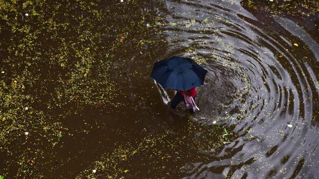 A man wades through a waterlogged street during heavy rain in Hyderabad on June 27. El Nino is a climate pattern characterised by high sea surface temperatures in the tropical Pacific Ocean, which are neutral now. El Nino years in India are linked to below normal monsoon rains, and higher than normal frequency of heat waves. (PTI)
