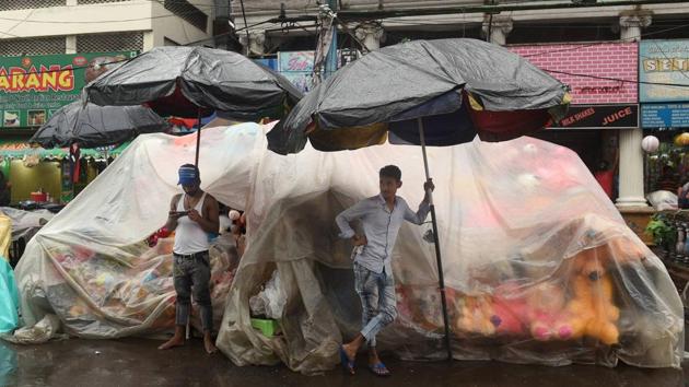 Roadside vendors wait for customers during rain in Kolkata on June 27. Due to the shifting of the monsoon trough northwards and convergence of strong southerly and south-westerly winds from Bay of Bengal over northeast and east India, the region has seen widespread and heavy to very heavy rainfall over the past three days. (Ashok Bhaumik / PTI)