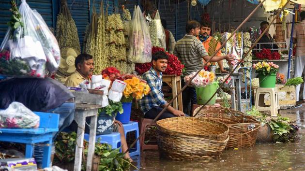 Flower vendors wait for customers along a waterlogged street after heavy rains in Patna on June 26. Fairly widespread rainfall over East Uttar Pradesh, Bihar and Sub-Himalayan West Bengal and Sikkim has been forecast during the next four days as the eastern end of monsoon trough continues to run along the foothills of Himalayas. (PTI)