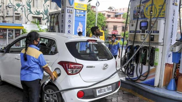 An employee fills fuel in a vehicle at a filling station.(PTI)