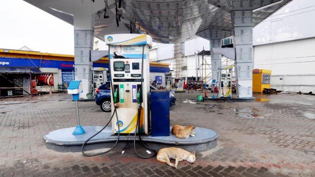 A couple of dogs nap near a fuel dispenser at a petrol pump amid the state government imposed he complete lockdown in Guwahati on June 29. As per the data released by health ministry yesterday, Assam remains the worst hit northeastern state in terms of caseload. The state has so far recorded only 11 deaths due to Covid-19. (ANI)