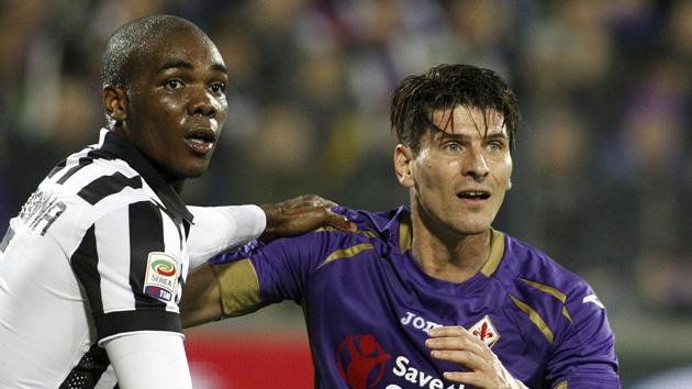 FILE - In a Friday Dec. 5 2014 file photo, Fiorentina's Mario Gómez and Juventu' Angelo Ogbonna hold each other during a Serie A soccer match at the Artemio Franchi stadium in Florence, Italy. Former Germany striker Mario Gómez has retired from soccer after scoring in his last game for Stuttgart. The soon-to-be 35-year-old says he has fulfilled his final wish – to help Stuttgart secure an immediate return to the Bundesliga after one season in the second division.(AP Photo/Fabrizio Giovannozzi, File)(AP)