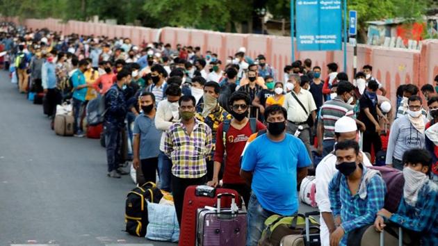 Migrant workers and their families wait in lines outside a railway station to board a train to their home state of eastern West Bengal, after authorities eased lockdown restrictions that were imposed to slow the spread of the coronavirus disease.(REUTERS) Migrant workers and their families wait in lines outside a railway station to board a train to their home state of eastern West Bengal, after authorities eased lockdown restrictions that were imposed to slow the spread of the coronavirus disease.(REUTERS)