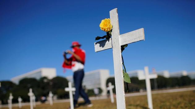Crosses symbolising the ones who died from the coronavirus disease (COVID-19) stand in front of the Brazilian National Congress during a protest against Brazil's President Jair Bolsonaro in Brasilia on June 28. The world has passed a sombre milestone in its fight against the global pandemic --over half a million lives lost and 10.2 million cases and counting as of June 29. (Adriano Machado / REUTERS)
