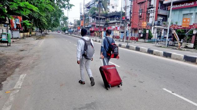 Passengers walk along an empty stretch of a road in Guwahati on June 29. Former chief minister Tarun Gogoi has criticised the decision to impose a stricter lockdown in Guwahati and blamed it on the inefficacy of Assam Health Minister Himanta Biswa Sarma. (ANI)