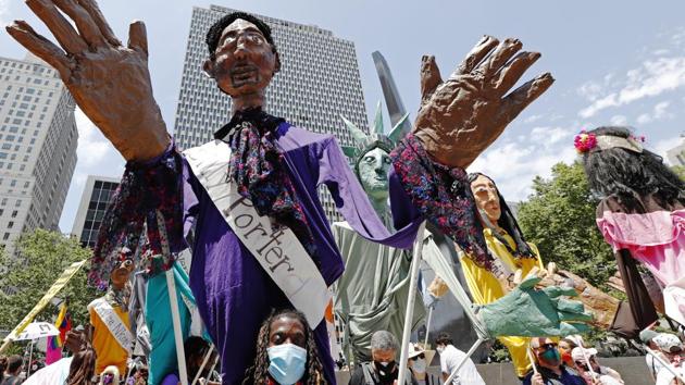 A man carries a Billy Porter puppet during a queer liberation march for Black Lives Matter and against police brutality, Sunday, June 28, 2020, in New York. The march commemorated the 50th anniversary of the gay Pride movement in lieu of New York's normally massive gay Pride celebration which was cancelled this year due to concerns over the spread of coronavirus. Porter is an openly gay performer. (AP)