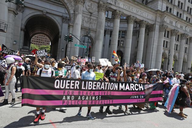 Protesters stretch out a banner at the beginning of a queer liberation march for Black Lives Matter and against police brutality, Sunday, June 28, 2020, in New York. (AP)