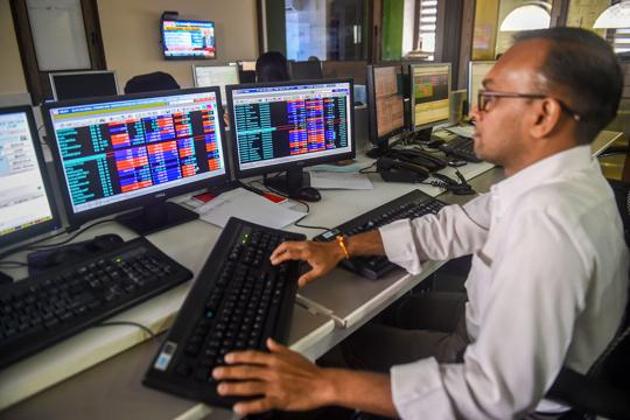 Traders monitor BSE index at a brokerage firm in Mumbai.(PTI File Photo)