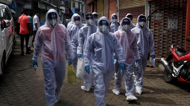 Healthcare workers wearing personal protective equipment (PPE) walk towards different localities before the start of a check-up camp for the coronavirus disease (Covid-19) in Mumbai.(REUTERS) Healthcare workers wearing personal protective equipment (PPE) walk towards different localities before the start of a check-up camp for the coronavirus disease (Covid-19) in Mumbai.(REUTERS)