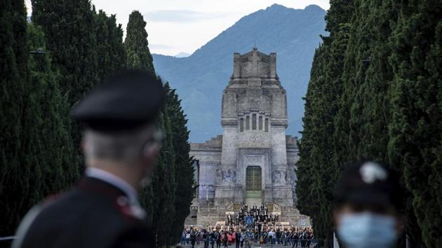 Carabinieri officers patrol the road leading to the Bergamo cemetery, Italy, Sunday, June 28, 2020. Italy bid farewell to its coronavirus dead on Sunday with a haunting Requiem concert performed at the entrance to the cemetery of Bergamo, the hardest-hit province in the onetime epicenter of the outbreak in Europe. (AP) Carabinieri officers patrol the road leading to the Bergamo cemetery, Italy, Sunday, June 28, 2020. Italy bid farewell to its coronavirus dead on Sunday with a haunting Requiem concert performed at the entrance to the cemetery of Bergamo, the hardest-hit province in the onetime epicenter of the outbreak in Europe. (AP)