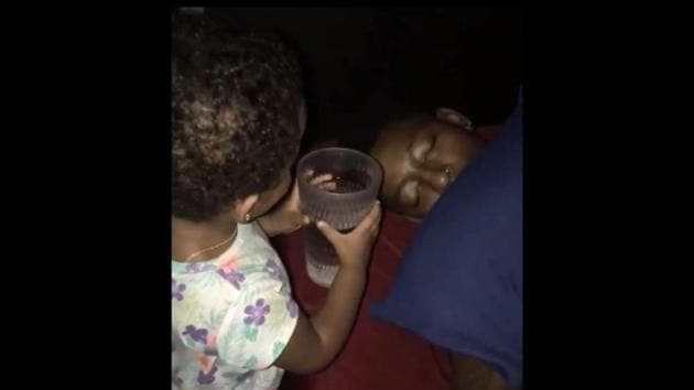 The image shows the little girl pouring water on her dad. (Instagram/@maajay) The image shows the little girl pouring water on her dad. (Instagram/@maajay)
