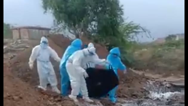 A video grab allegedly showing members of a field team dumping bodies of Covid-19 patients in an open pit.(ANI)
