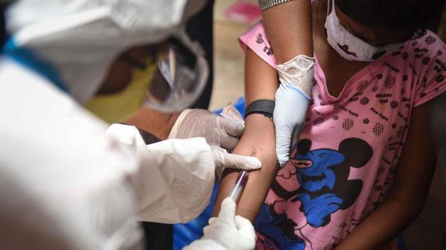 A medical personnel draws a blood sample to test for COVID-19 infection as part of Delhi’s serological survey on June 27. The serological survey of 20,000 people is another aspect of the new action plan --its results are expected to strengthen existing contact-tracing and surveillance policies. (Sanchit Khanna / HT Photo)