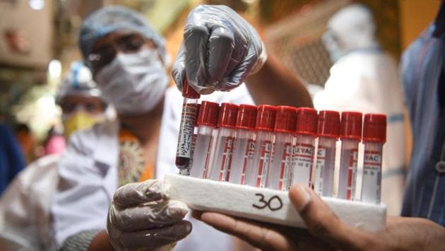 A medical professional handles a blood sample collected as part of the serological survey in New Delhi on June 27. The use of rapid antigen tests in containment zones, which help authorities isolate positive cases within 30 minutes, since June 18 has also helped identify new clusters of Covid-19 cases and redraw boundaries, an HT report stated. (Sanchit Khanna / HT Photo)
