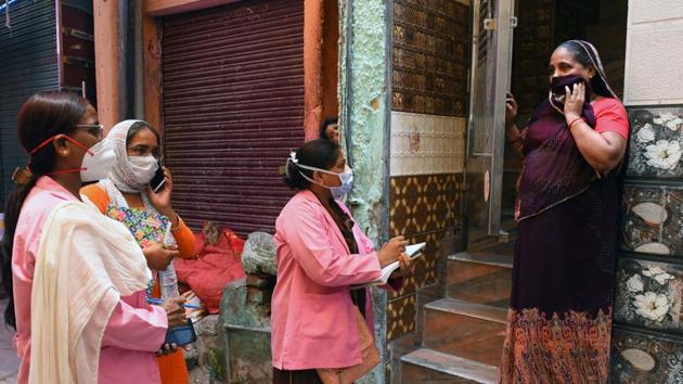 ASHA workers on a door to door screening survey for coronavirus in the Nabi Karim locality which has several pockets demarcated as containment zones, on June 26. 11 districts in Delhi have initiated a health survey of more than 250,000 individuals in the capital’s containment zones as part of the recommendations from the meeting with the home minster. (Mohd Zakir / HT Photo)