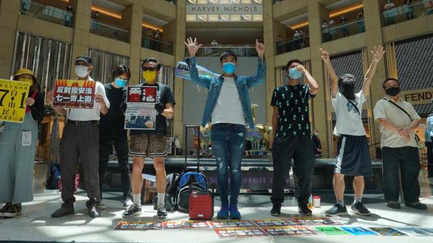 Protesters gather at a shopping mall in Hong Kong’s Central district during a pro-democracy protest against Beijing's national security law on June 30. More than a hundred protesters gathered at the luxury mall, chanting slogans including “Free Hong Kong, Revolution Now,” with several holding up a flag representing an independent Hong Kong as well as posters condemning the law. (Vincent Yu / AP)