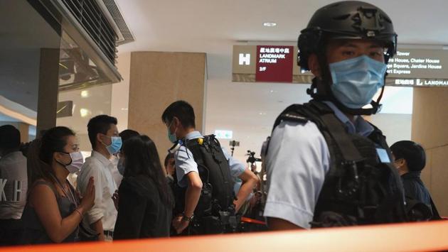A police officer (C, rear), confronts protesters to detain them at a shopping mall during a pro-democracy protest in Hong Kong on June 30. After the law passed, prominent Hong Kong pro-democracy activists Joshua Wong, Agnes Chow and Nathan Law issued statements on Facebook saying they would withdraw from the pro-democracy organization Demosisto. (Vincent Yu / AP)