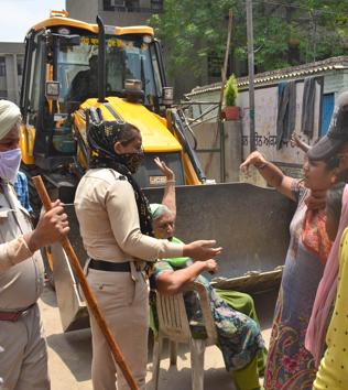 Residents of Model house arguing with police during an encroachment drive by LIT in the area on Tuesday. (GURPREET SINGH/HT) Residents of Model house arguing with police during an encroachment drive by LIT in the area on Tuesday. (GURPREET SINGH/HT)