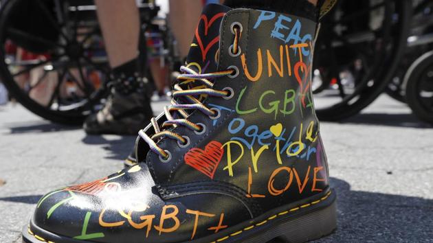 A person wears pride themed boots as they await the start of a queer liberation march for Black Lives Matter and against police brutality in New York. The march commemorated the 50th anniversary of Pride after New York's normally massive gay Pride march was cancelled due to concerns over the spread of coronavirus. (AP)