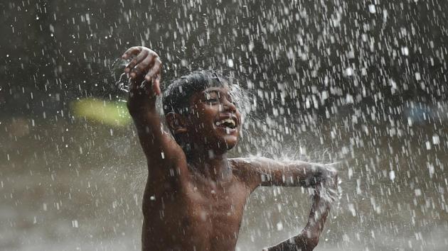 Mumbai: A boy reacts during monsoon rain, in Mumbai.(PTI)