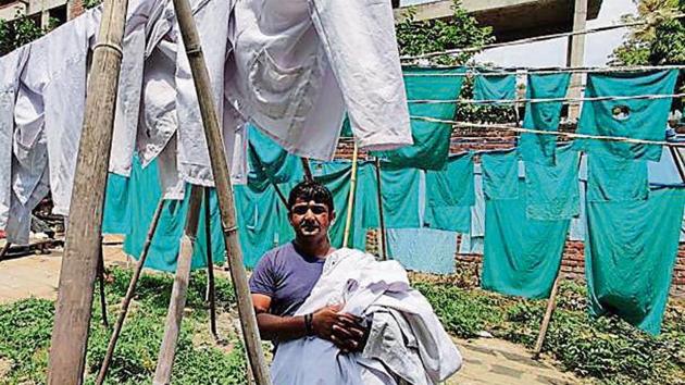 Hospital linen and uniforms drying at dhobi ghat number 28, on Deen Dayal Upadhyay Marg.(HT)