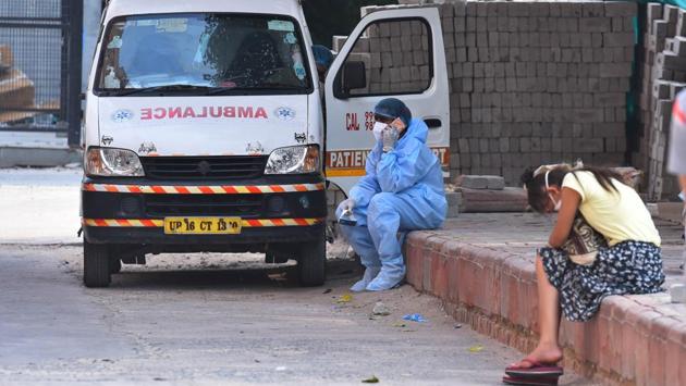 A medical professional in PPE coveralls speaks on the phone outside the Covid-19 ward at Lok Nayak Jai Prakash Hospital in New Delhi. There are 347,978 people who have been discharged from hospitals across the country, as of this morning. (Raj K Raj / HT Photo)