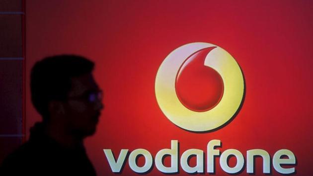 A man casts a silhouette onto an electronic screen displaying a Vodafone logo, in Mumbai. (REUTERS) A man casts a silhouette onto an electronic screen displaying a Vodafone logo, in Mumbai. (REUTERS)