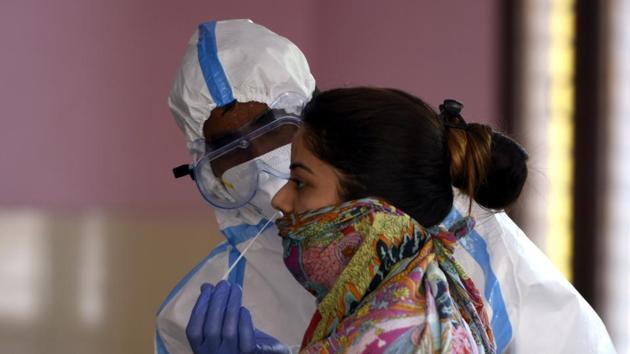 File photo: A health worker collects a swab sample from a local resident to test for coronavirus infection. (Parveen Kumar/Hindustan Times) File photo: A health worker collects a swab sample from a local resident to test for coronavirus infection. (Parveen Kumar/Hindustan Times)