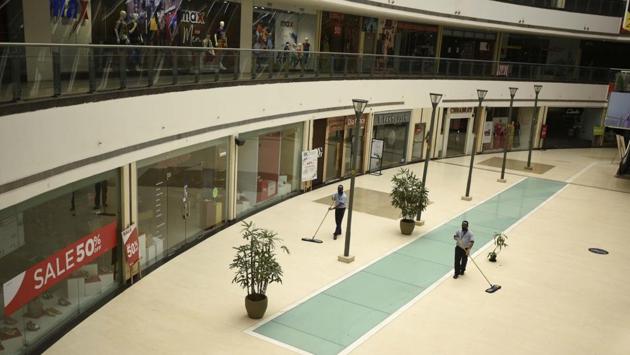 Housekeeping staff at work in a mall on June 30 ahead of its reopening in Gurugram. The plan to unlock the country looks to bring stalled businesses and activities back on track. The government has so far allowed the functioning of public and private offices in a graded manner and also allowed the conditional reopening of shops and marketplaces. (Parveen Kumar / HT Photo)
