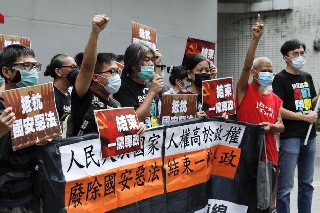 Pro-democracy Leung Kwok-hung, center, and others protesters shout slogans " Stop One Party Rolling" before they march toward the flag raising ceremony marking the anniversary of the Hong Kong handover to China in Hong Kong on Wednesday (AP Photo) Pro-democracy Leung Kwok-hung, center, and others protesters shout slogans " Stop One Party Rolling" before they march toward the flag raising ceremony marking the anniversary of the Hong Kong handover to China in Hong Kong on Wednesday (AP Photo)
