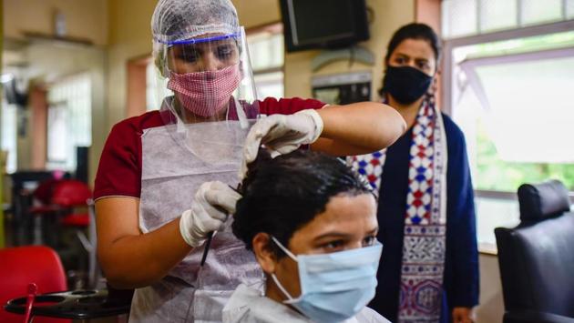 A woman wears a face mask as she gets her hair coloured at Lee’s salon on Karve road in Pune. India’s first Covid-19 vaccine candidate by Bharat Biotech Ltd has received the central drugs controller’s approval for human clinical trials, reported HT. (Sanket Wankhade / HT Photo)