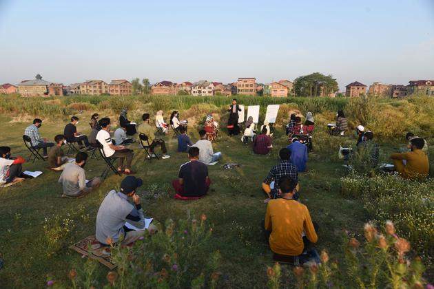 Students attend an open-air class as educational institutions continue to remain closed due to precautions against the coronavirus in Srinagar on July 01. India entered Unlock2.0, the second of a three-phase plan aimed at lifting restrictions imposed to stop the spread of the coronavirus disease (Covid-19) today. While some relaxations have been added in this phase, they do not extend to schools and colleges. (Waseem Andrabi / HT Photo)