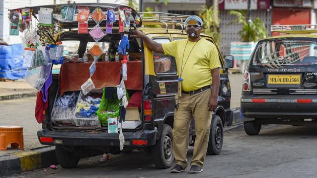 Deepak Pathak, a taxi driver by profession, waits for customers at his make-shift shop in Mumbai. Due to lack of work amid the coronavirus pandemic, Pathak now sells face masks to sustain his livelihood. (Kunal Patil / PTI) Deepak Pathak, a taxi driver by profession, waits for customers at his make-shift shop in Mumbai. Due to lack of work amid the coronavirus pandemic, Pathak now sells face masks to sustain his livelihood. (Kunal Patil / PTI)