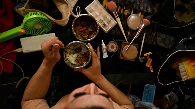 A transgender performer eats a meal next to a makeup kit before the start of a lotto show. “Not many people from the LGBT community have top class jobs... we generally don’t make it to higher education because we are bullied at school,” Nha Vy told AFP. (Manan VATSYAYANA / AFP) A transgender performer eats a meal next to a makeup kit before the start of a lotto show. “Not many people from the LGBT community have top class jobs... we generally don’t make it to higher education because we are bullied at school,” Nha Vy told AFP. (Manan VATSYAYANA / AFP)