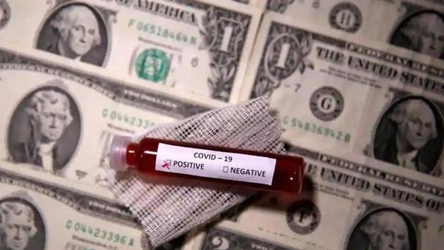 Test tube with fake blood labelled with the coronavirus disease (Covid-19) is placed on dollar banknotes in this illustration taken March 27, 2020. (Reuters File Photo) Test tube with fake blood labelled with the coronavirus disease (Covid-19) is placed on dollar banknotes in this illustration taken March 27, 2020. (Reuters File Photo)