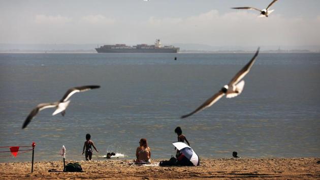 People enjoy an afternoon at the beach at Brooklyn’s Coney Island on the first day that swimming is allowed at New York City beaches on July 01. The state of New York led the ‘first-wave states’ that included New Jersey, Illinois, Massachusetts and Pennsylvania when the coronavirus first swept through the country in March. Cases in these states peaked in early April, but those gains now appear coming undone. (Spencer Platt / Getty Images / AFP) 