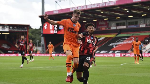 Bournemouth's Lloyd Kelly, right, duels for the all with Newcastle's Emil Krafth during the English Premier League soccer match between Bournemouth and Newcastle at Vitality Stadium in Bournemouth, England, Wednesday, July 1, 2020. (Glynn Kirk/Pool via AP)(AP)