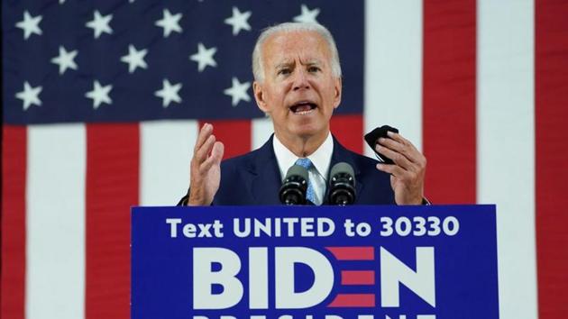 Democratic US presidential candidate and former Vice President Joe Biden holds his protective face mask as he speaks about the Trump administration's handling of the coronavirus pandemic during a campaign event in Wilmington, Delaware, US on June 30, 2020.(Reuters Photo)