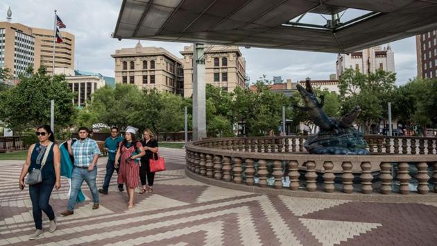 A family celebrating a graduation is seen without face masks as they walk through San Jacinto Plaza in El Paso, Texas on July 1. In the first week of June, the US was adding about 22,000 new cases every day. But as the month progressed, hotspots began to emerge across its southern states. In the last seven days of June, daily new infections almost doubled to 42,000 nationally. (Cengiz Yar / Getty Images / AFP) 