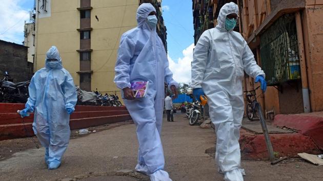 BMC Health workers exit a housing society after conducting door-to-door screening of local residents in Dharavi, Mumbai. According to the Johns Hopkins University’s coronavirus tracker there are 10,668,410 Covid-19 cases and 515,694 people have died due to the coronavirus disease (Covid-19) across the world. (Vijayanand Gupta / HT Photo)