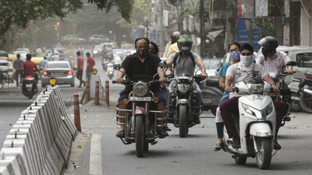 Commuters wearing face masks seen on the road in Jangpura, New Delhi. According to government data, at the beginning of June, Delhi was conducting around 5,000 tests every day. This now has been scaled up to 17,000-20,000 every day. (Biplov Bhuyan / HT Photo) 