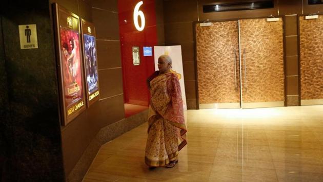 A woman looks at posters of Bollywood films at the lobby of a PVR Multiplex in Mumbai November in file photo.(REUTERS)