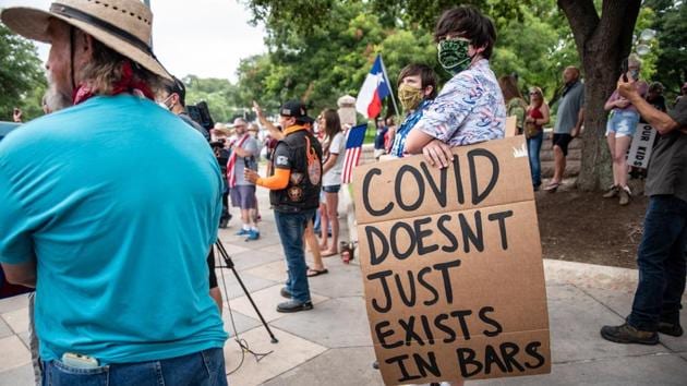 Demonstrators gather in front of the Texas State Capital during a “Bar Lives Matter” protest against an order for their closure amid surging Covid-19 cases in Austin, Texas on June 30. While cases are rising in the southern states, the reasons behind the surges have health experts and state governments divided.  (Sergio Flores / Bloomberg) 