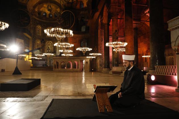 FILE - In this Friday, May 29, 2020 file photo, a Muslim cleric recites the "prayer conquest" from the Quran, Islam's holy book, inside Istanbul's 6th-century Hagia Sophia — the main cathedral of the Byzantine Empire which was converted into a mosque with the Ottoman conquest of the city, then known as Constantinople, in 1453, in Istanbul. (AP)