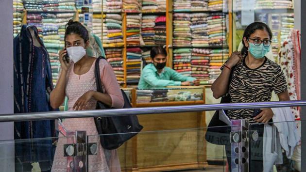 Shoppers at a mall on MG Road in Gurugram on July 1. Hariom Attri, joint commissioner, Municipal Corporation of Gurugram (MCG) said that despite surprise visits to all malls, not a single challan was issued on the first day. “The footfall across all malls in the city was extremely low. Hence, there was little to no scope for people to flout norms. Even I visited some malls at random and found everything to be in order,” Attri told HT. (PTI)