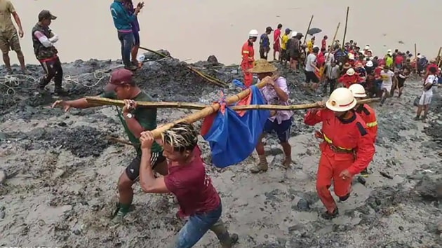 A heap of mining waste collapsed into a lake on Thursday and buried many workers under mud and water. (AP Photo) A heap of mining waste collapsed into a lake on Thursday and buried many workers under mud and water. (AP Photo)