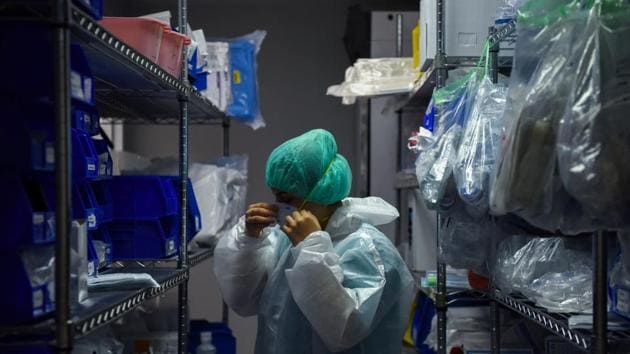 A medical worker puts on protective equipment as hospital staff treat coronavirus disease patients at the United Memorial Medical Center’s coronavirus disease intensive care unit in Houston, Texas, US.(REUTERS)