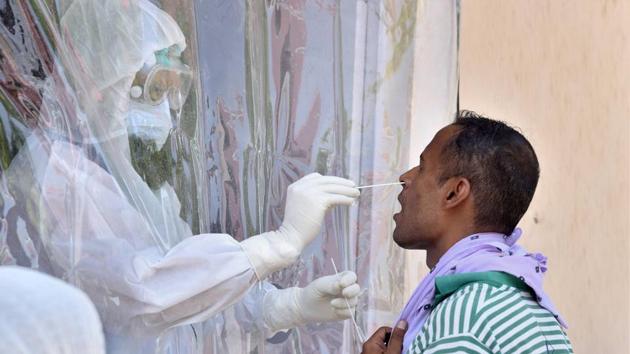 Bikaner: A health worker collects swab sample of man for COVID-19 test, during a health check-up camp, in Bikaner, Friday, July 3, 2020.(PTI)