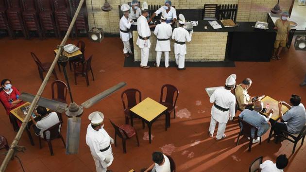 An overview of the dining room at the Indian Coffee house shows tables laid out at a distance in the establishment, as it reopened to customers on July 2. However, the reopening comprised less than half the seating capacity, sans porcelain cups and dishes and limited items on the menu. (Samir Jana / HT Photo)